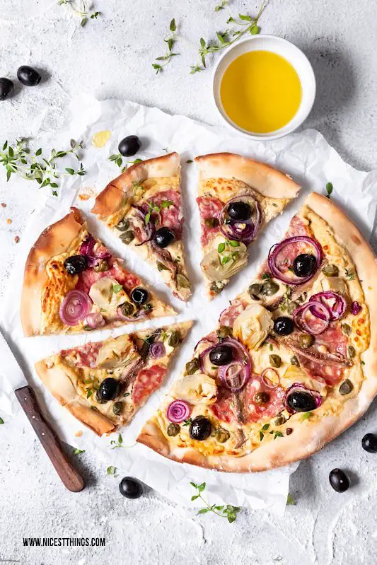 Pizza Bianca Rezept mit Kichererbsen Creme, Salami, Kapern, Artischocken und Oliven #pizza #pizzarezepte #pizzabianca #artischocken #kichererbsen #oliven #salami #sardellen #kapern #italianfood